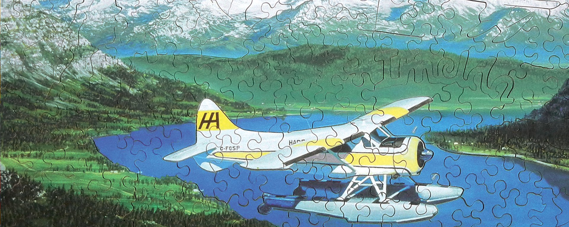 Wooden aviation puzzle featuring a seaplane that landed on a lake surrounded by mountains.